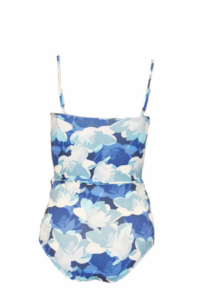 A blue floral pattern one piece swimsuit that has thin straps and waist tie. The swimsuit is made from recycled, sustainable material